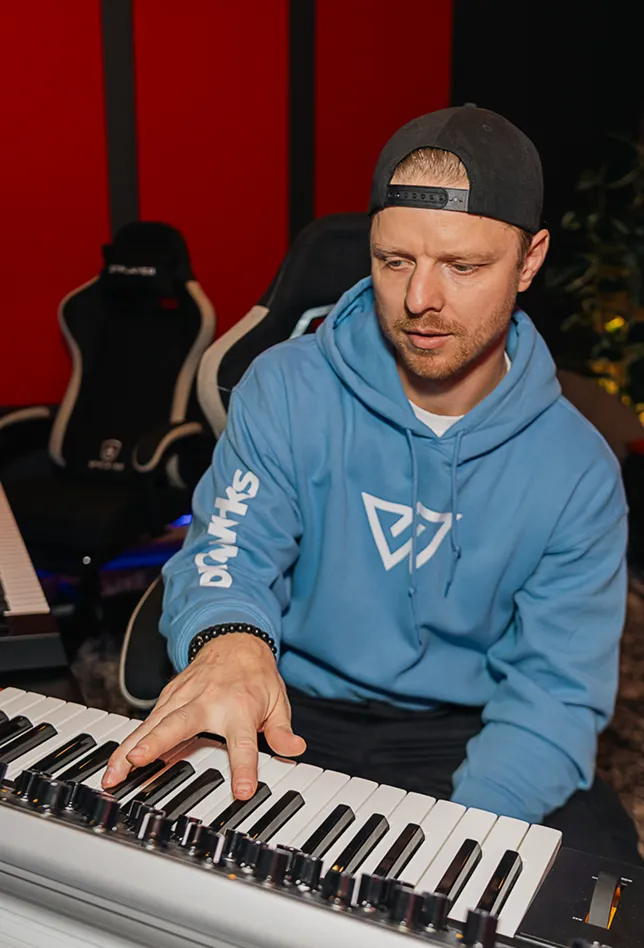 Music producer playing a keyboard in a studio