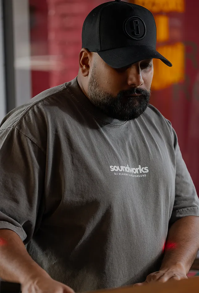 DJ wearing a Soundworks t-shirt performing indoors