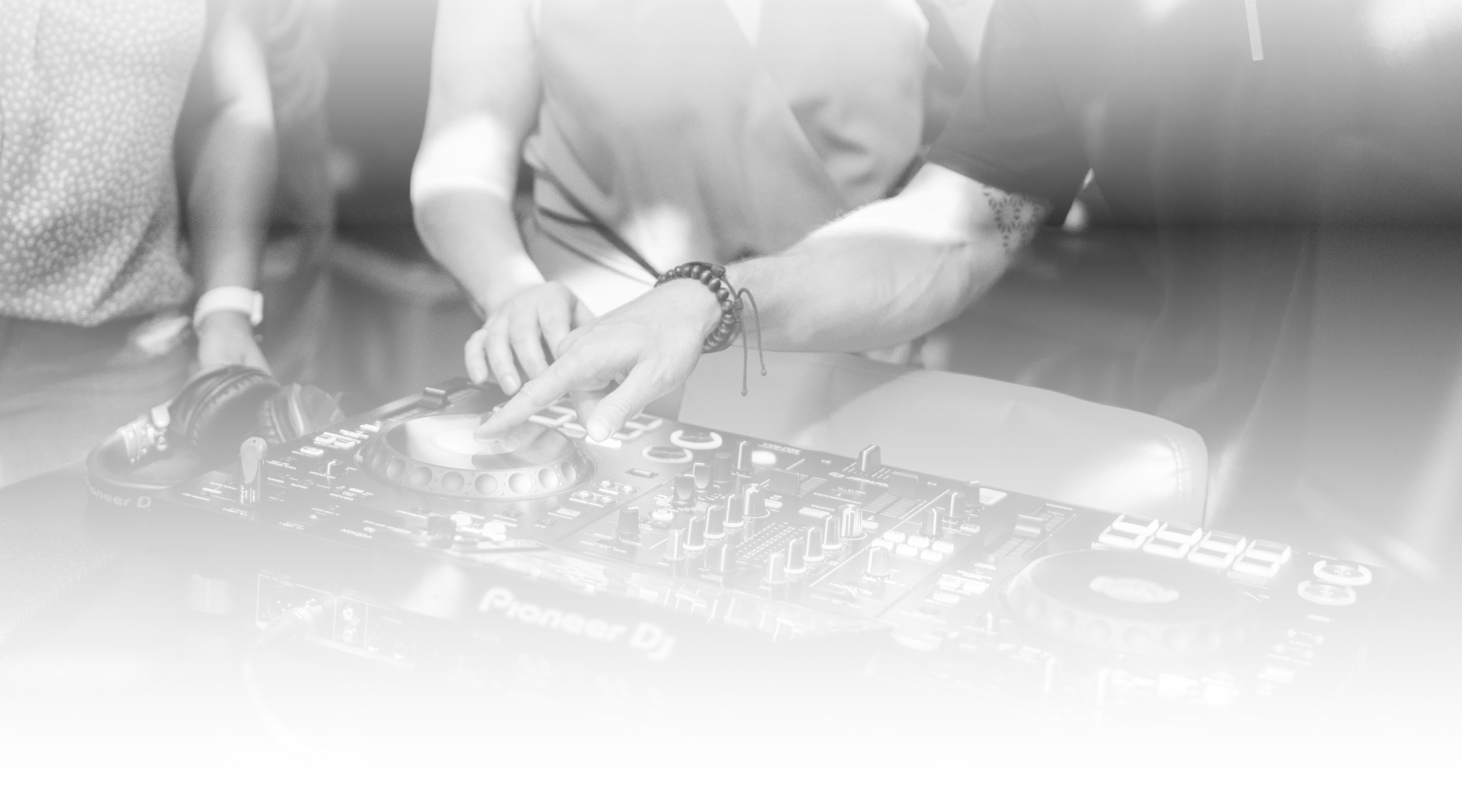 Hands adjusting controls on a DJ mixer