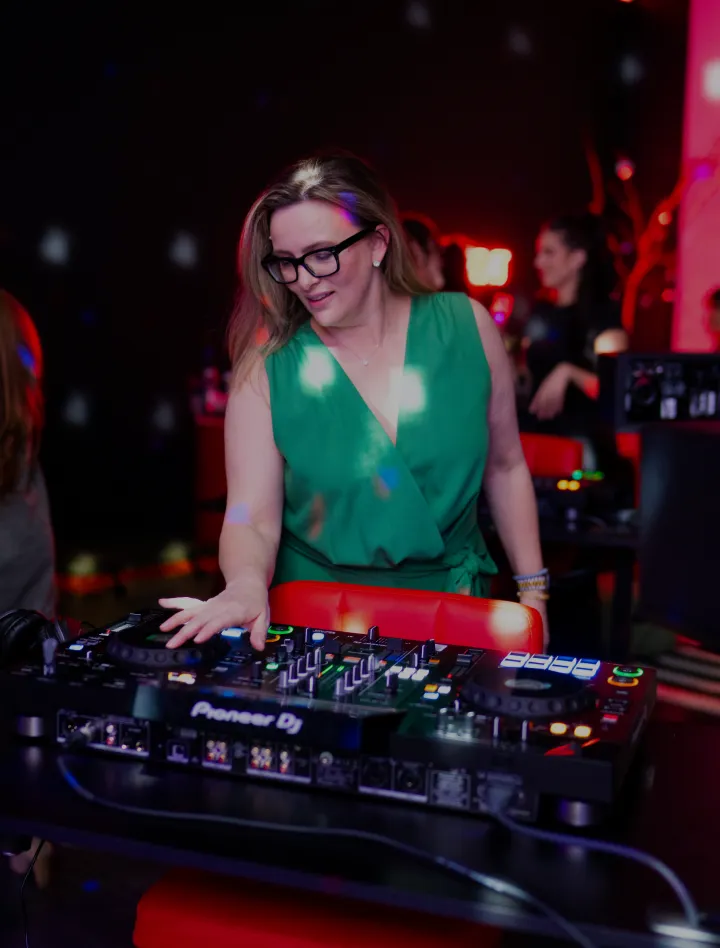 Woman learning DJ controls on a Pioneer controller