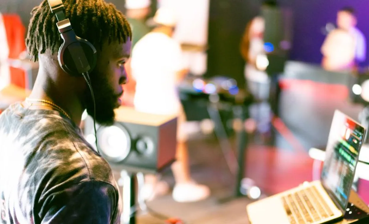 DJ working on a laptop during a live session
