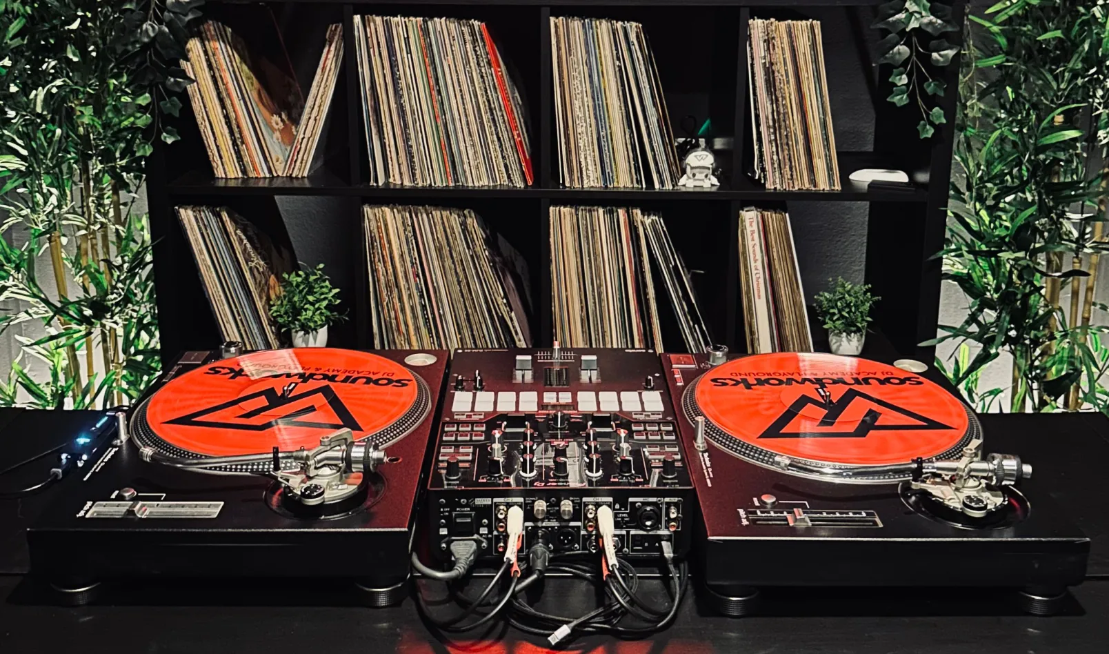 Turntables with vinyl records displayed on a DJ setup