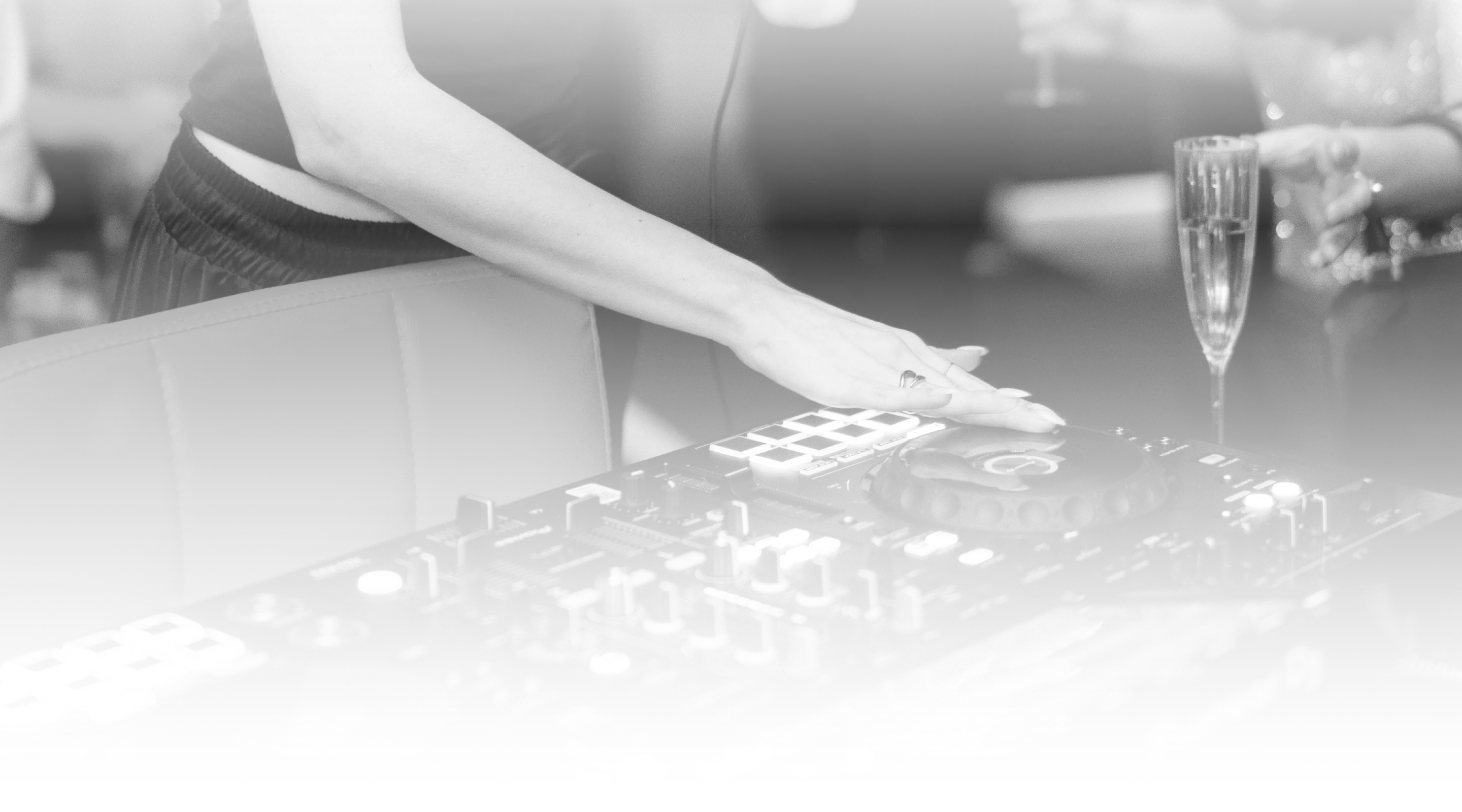 Close-up of a DJ hand adjusting controller knobs