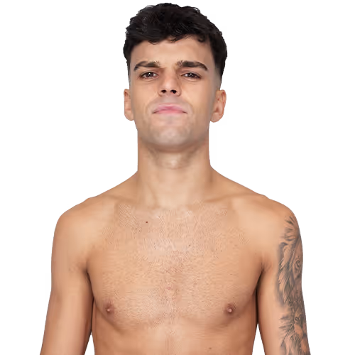 Young shirtless man with short black hair, looking forward with a neutral expression and a tattoo on his left arm.
