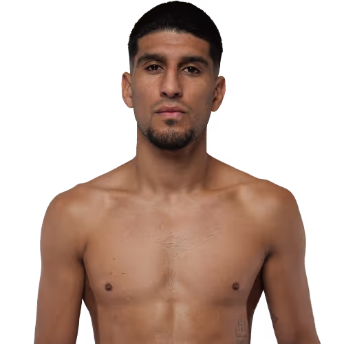 Portrait of a shirtless young man with short black hair and trimmed beard, looking directly at the camera.