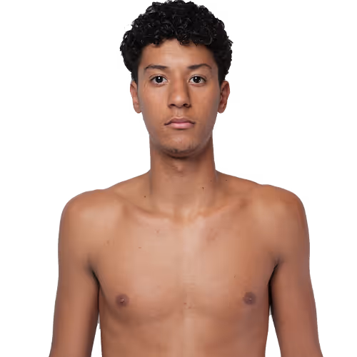 Portrait of a young man with short curly hair, bare-chested, looking straight ahead with a neutral expression.