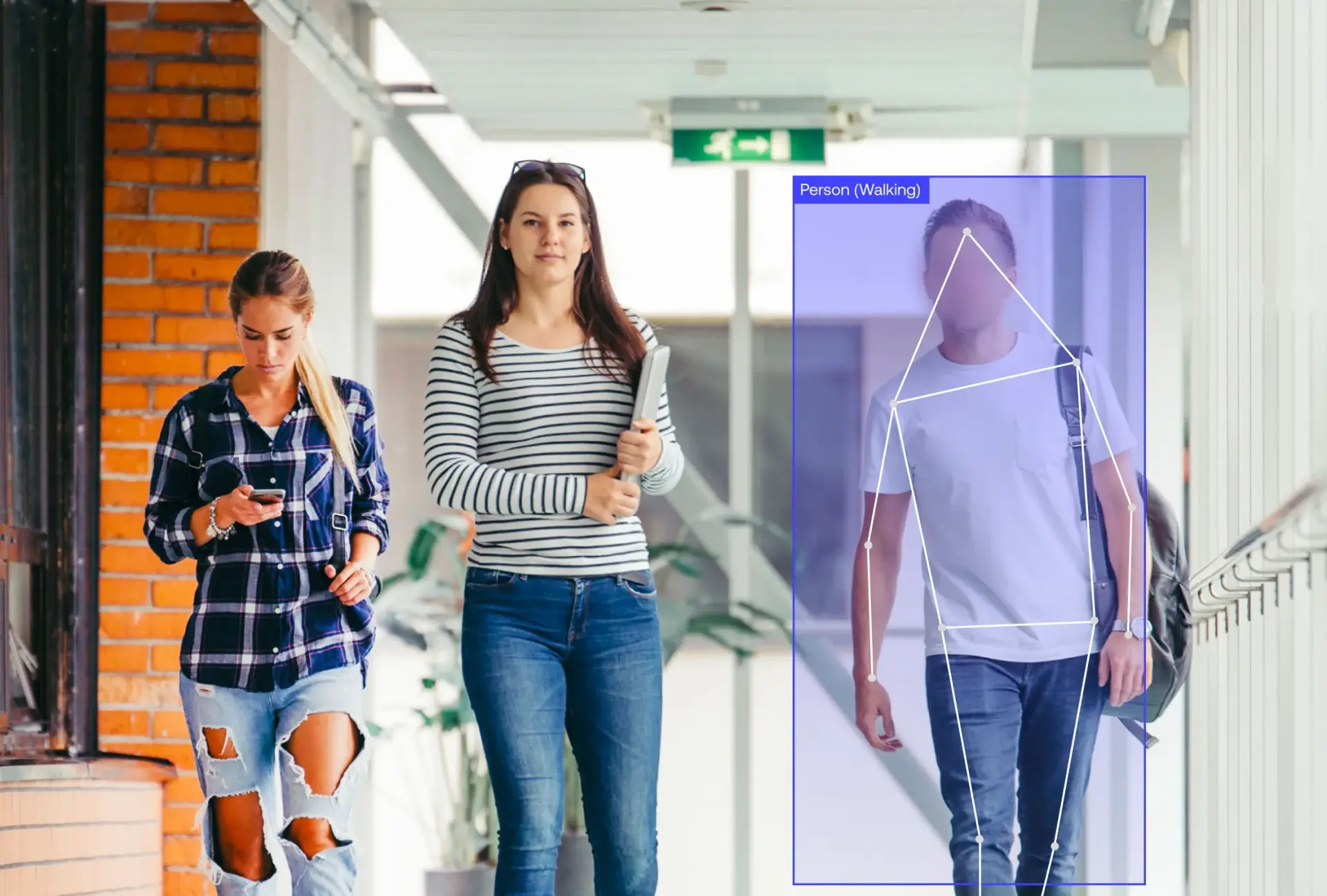 Students walking down a hallway next to each other.
