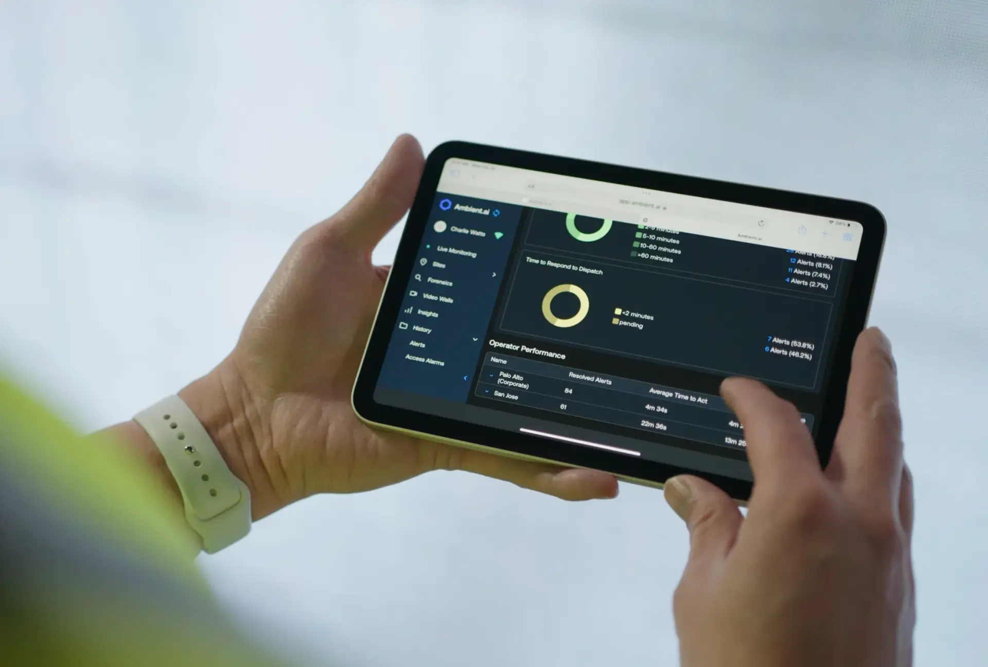 A person holding a tablet with a screen displaying a program.