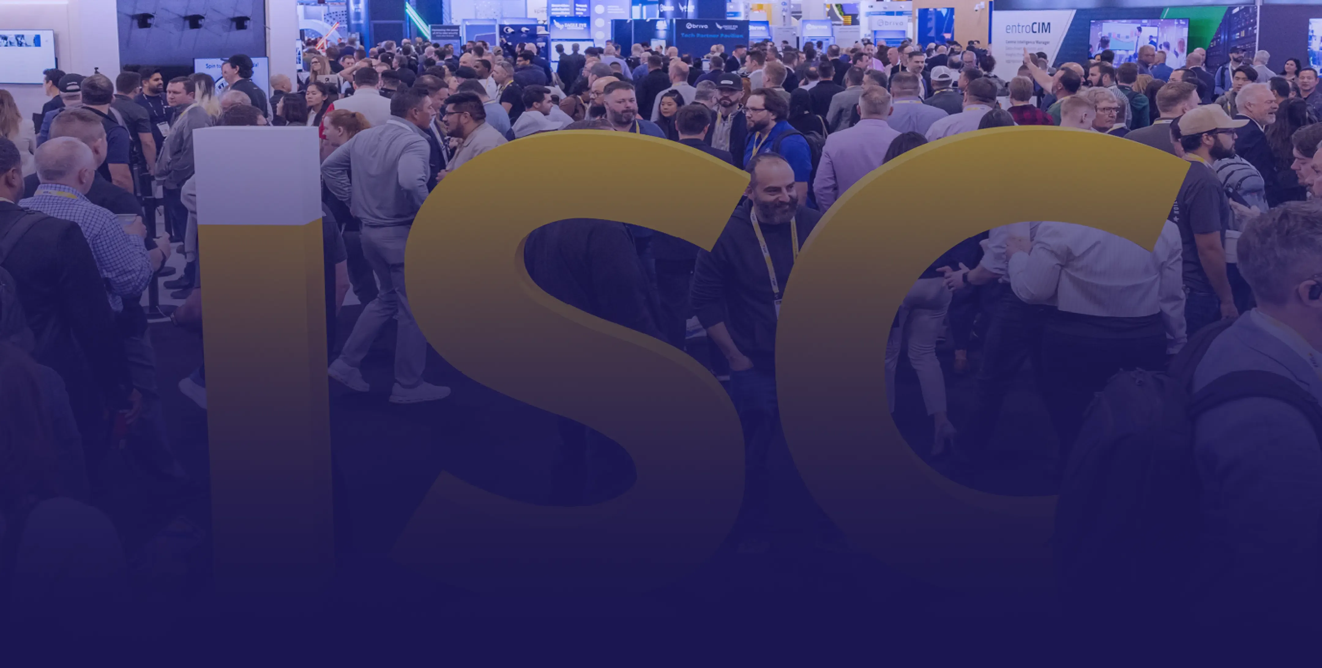 A large group of people standing around a convention hall.