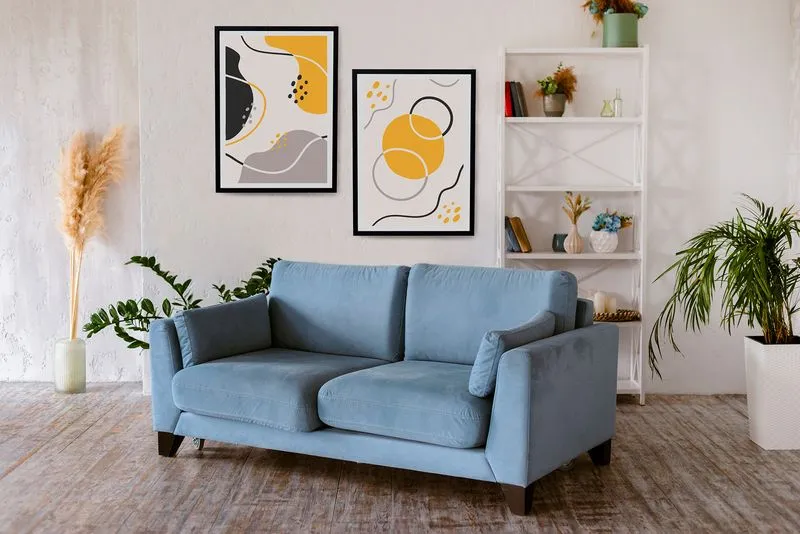 Cozy living room with blue sofa, abstract art, and plants