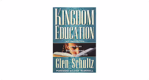 Book cover of 'Kingdom Education' by Glen Schultz with a wooden desk and paper clip design.
