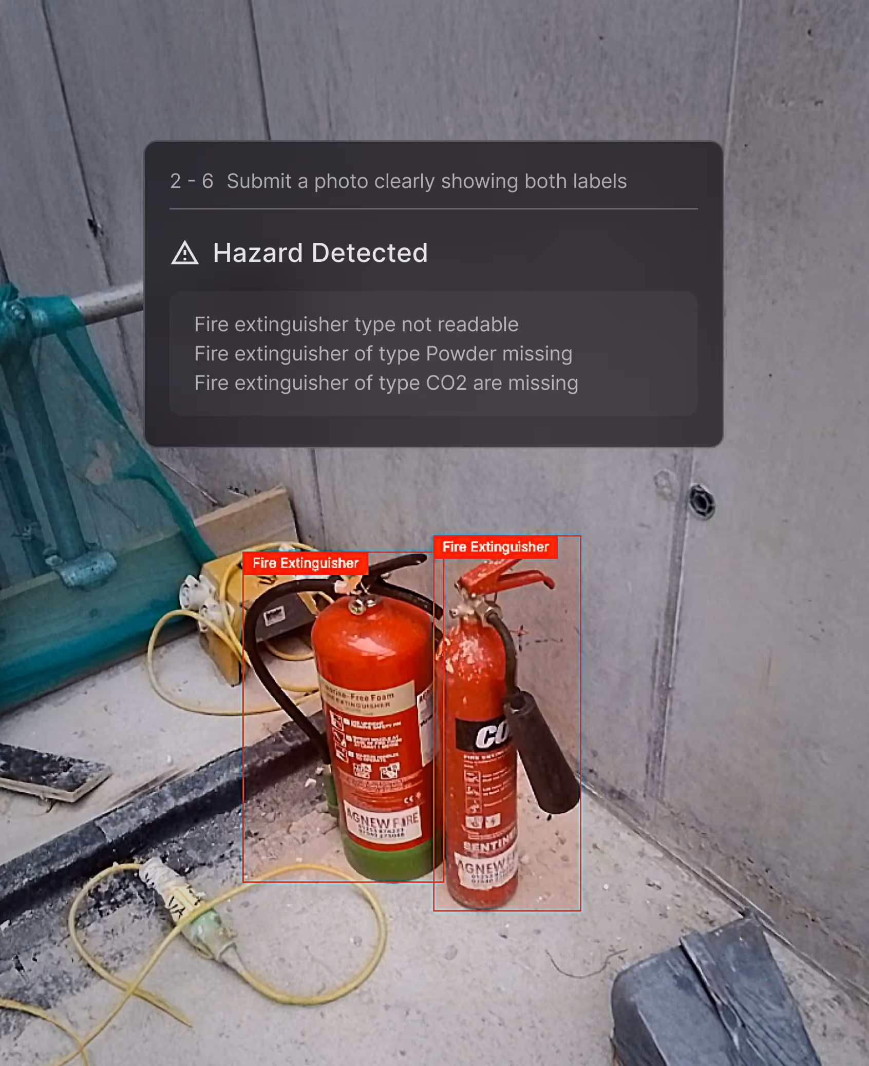 Two fire extinguishers on a concrete floor near construction materials with a warning overlay indicating hazard detected and missing extinguisher types.