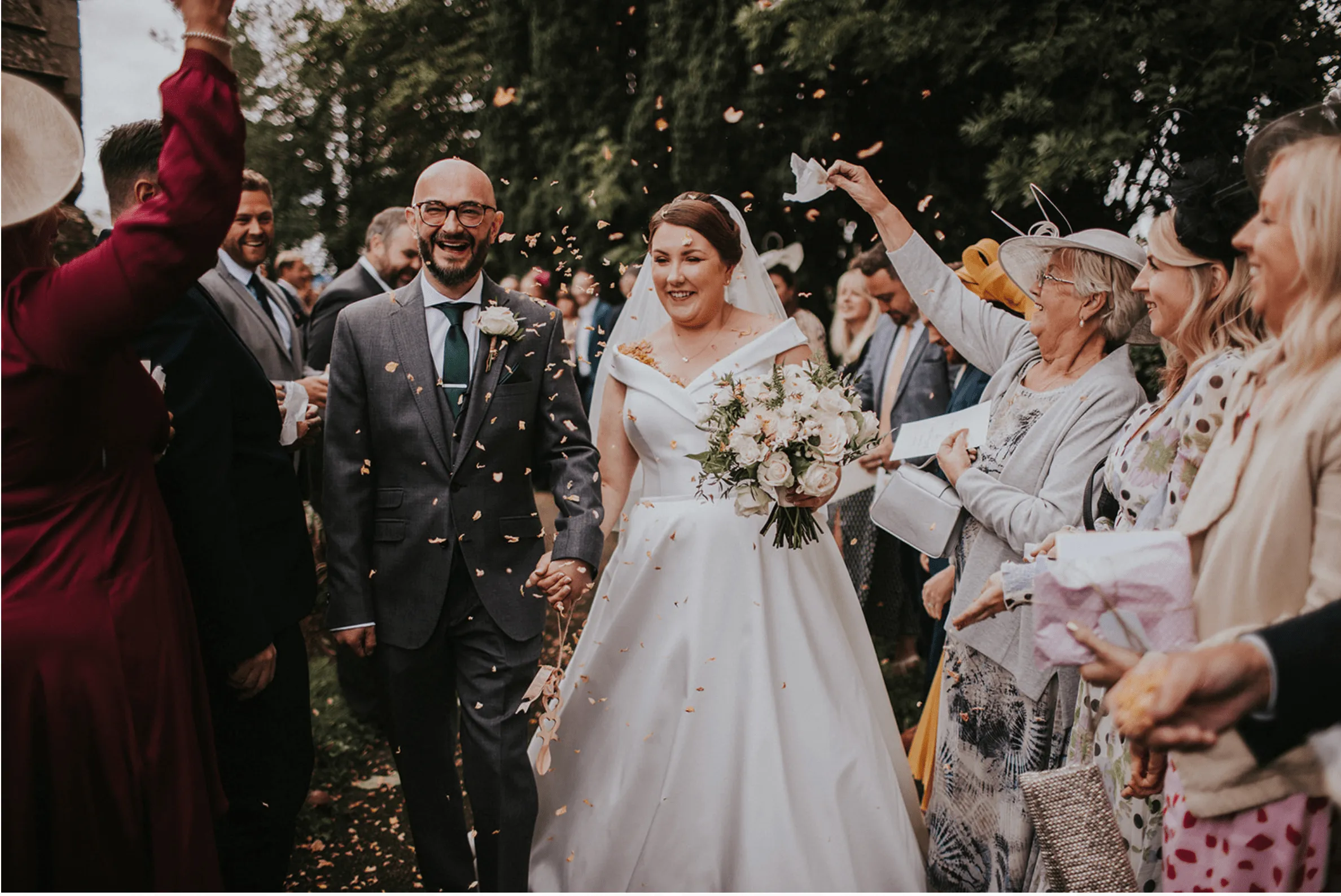 A newly married couple walking out of the wedding ceremony.