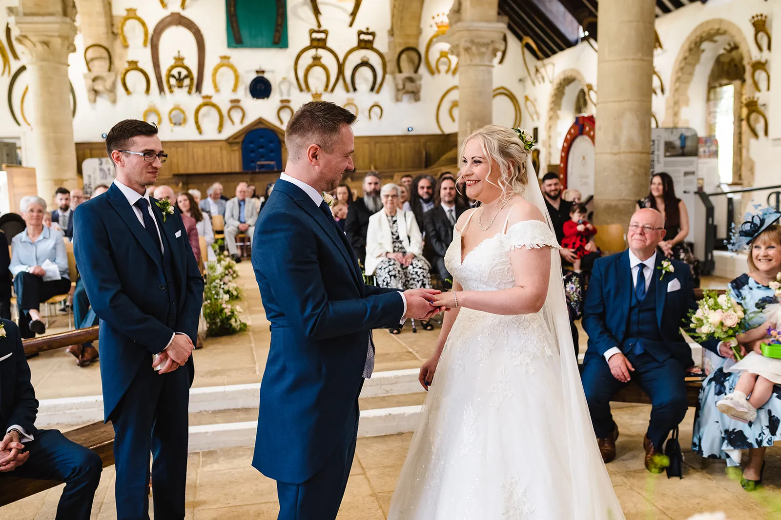 Bride and groom holding hands at the top of the aisle. 