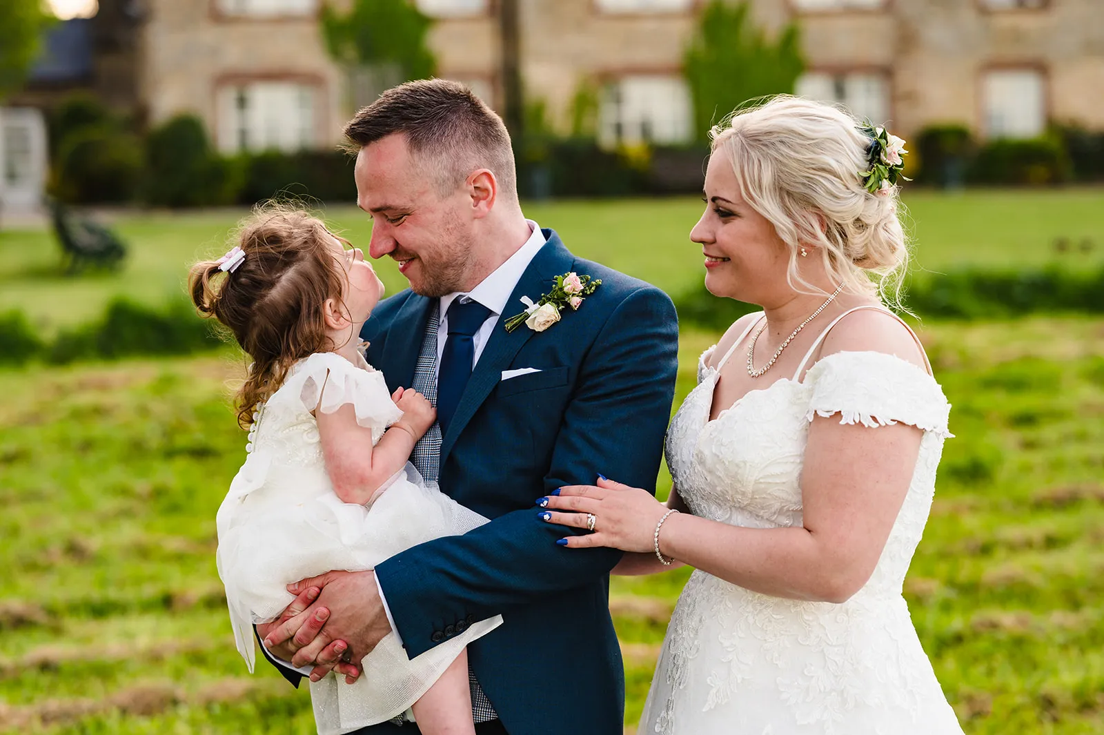 Newly married couple and their daughter pictured on their wedding day. 