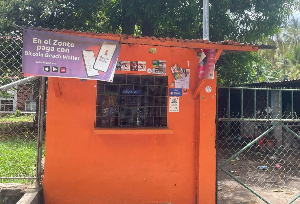 An orange building with a sign on the sideDescription automatically generated