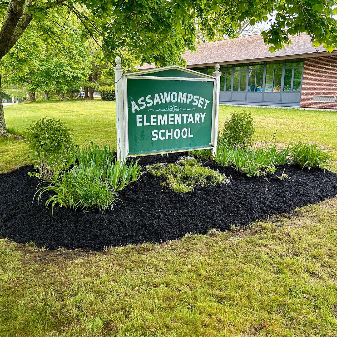 Local lawn care and landscaping professionals at work in Massachusetts