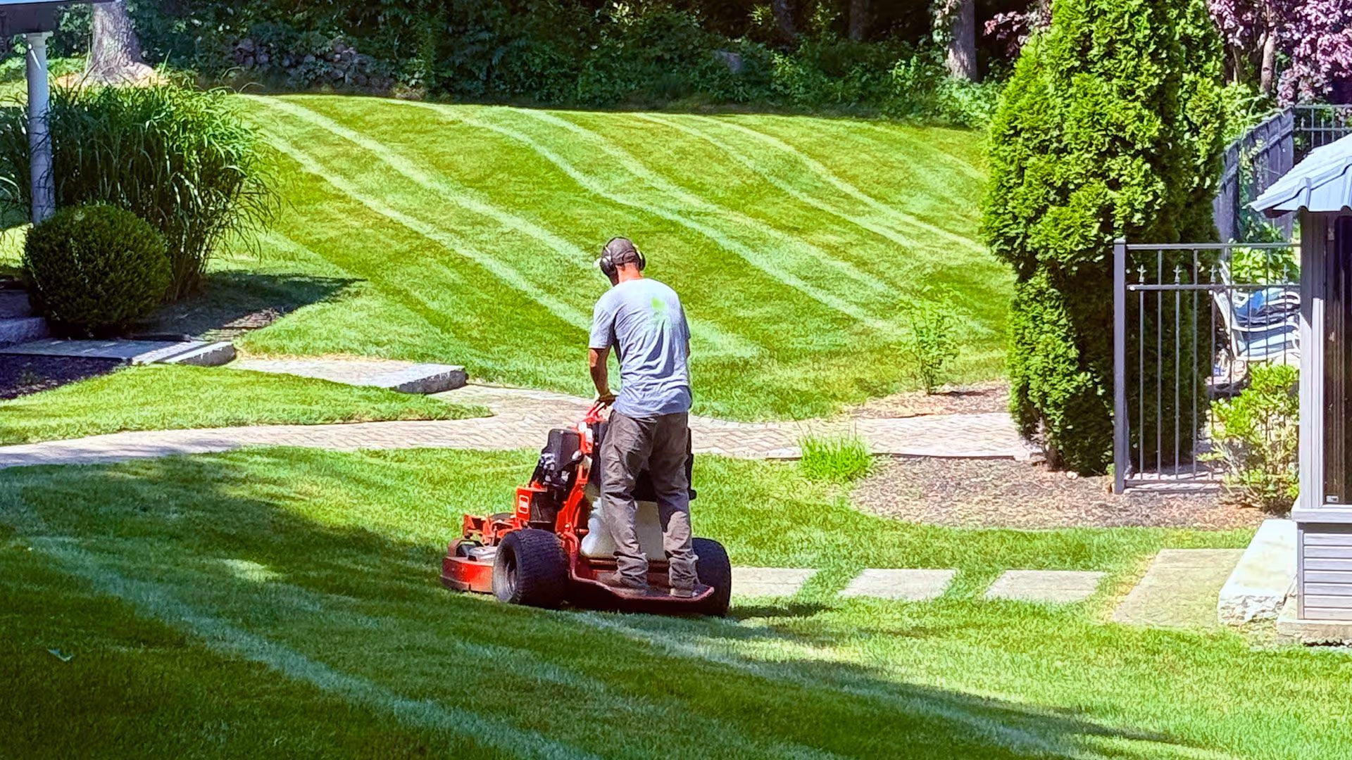 Landscaping team performing detailed mowing and trimming service