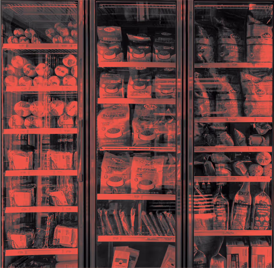 freezer interior with raw meat packages lit by red light