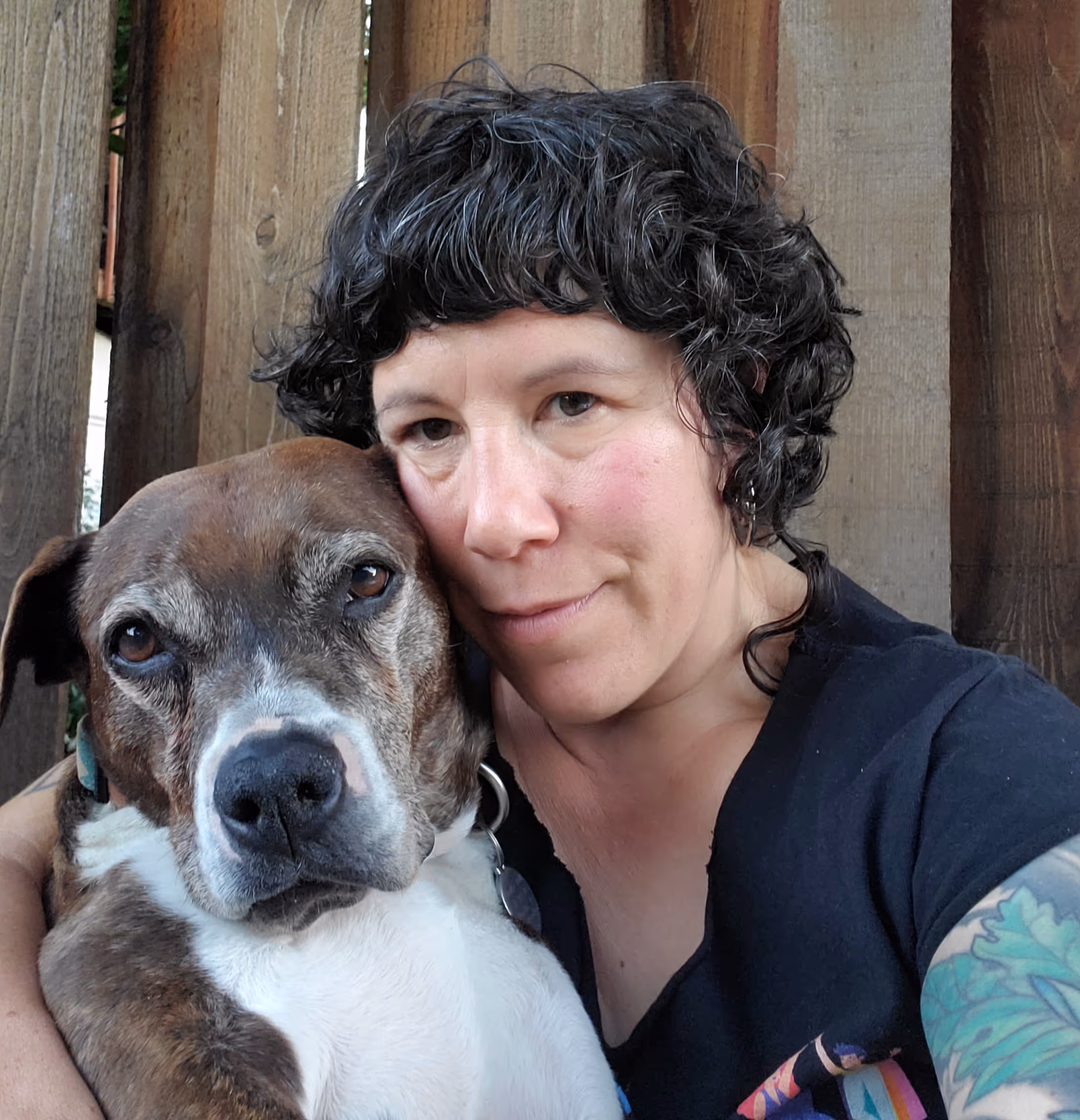 Heidi, the owner of Meat, with her brown and white dog