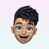 Smiling 3D avatar of a person with glasses and black hair styled upward.