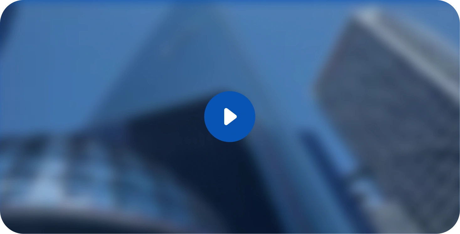 Blurred view of tall modern glass and steel office buildings under a blue sky.