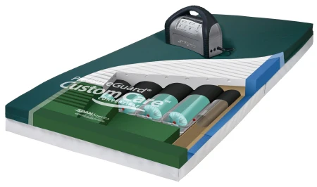 Cutaway view of a Custom Care e-Guard sleep system mattress with an electronic pump on top.