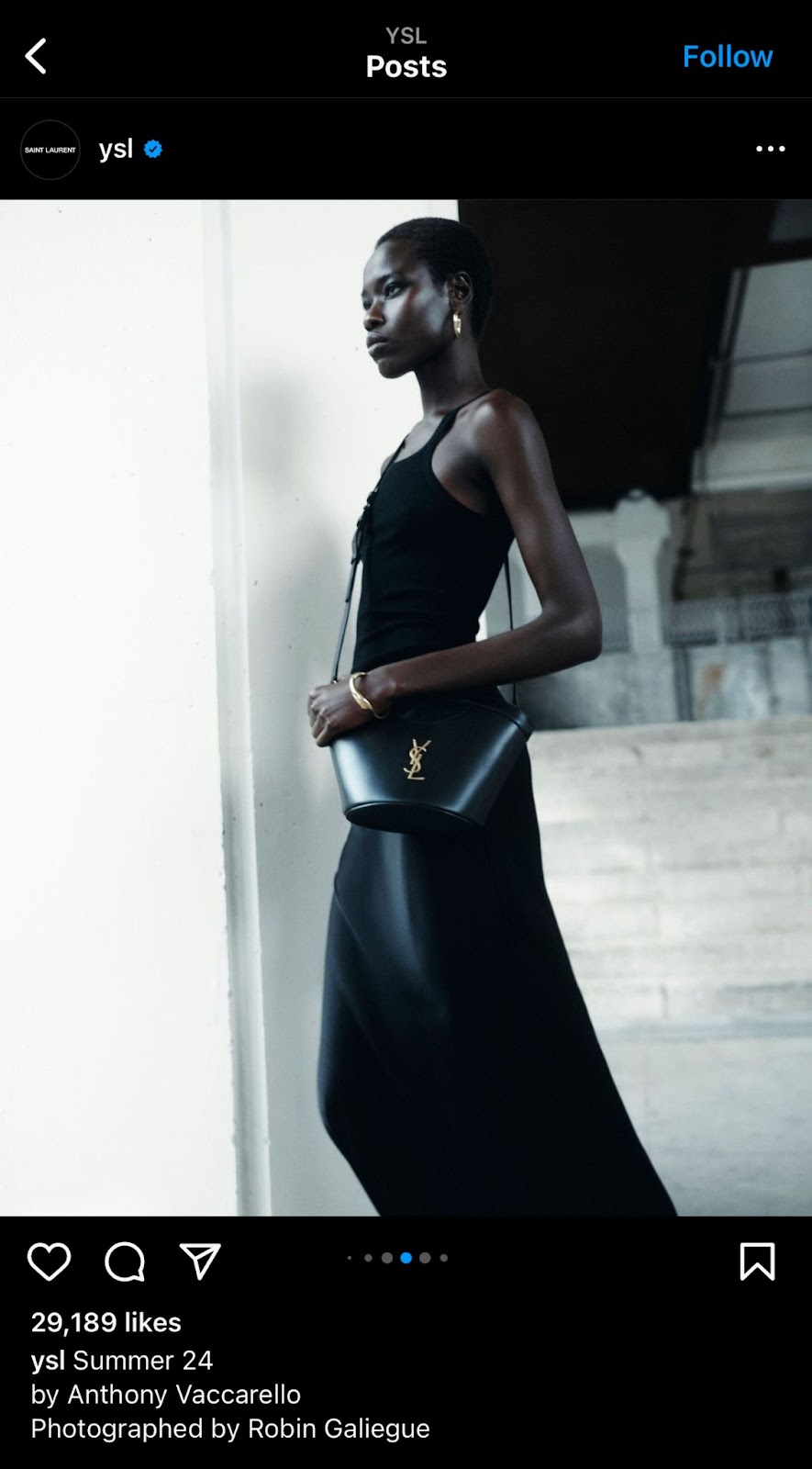 Women wearing black dress holding saint laurent bag