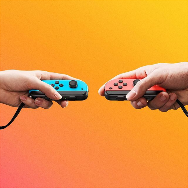 two hands holding red and blue switches