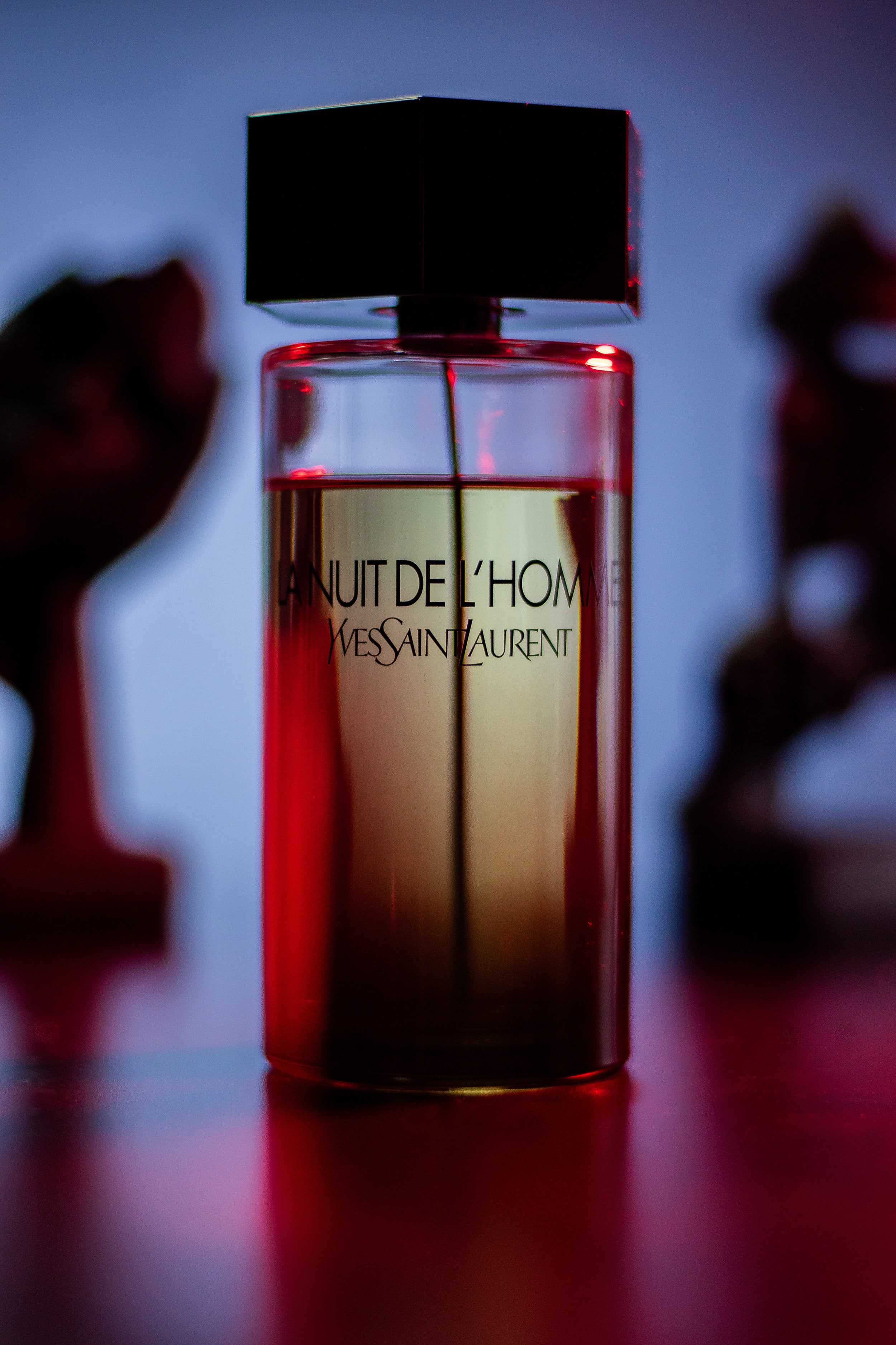 Shot of La Nuit de L’Homme with soft red background lighting for dramatic effect.