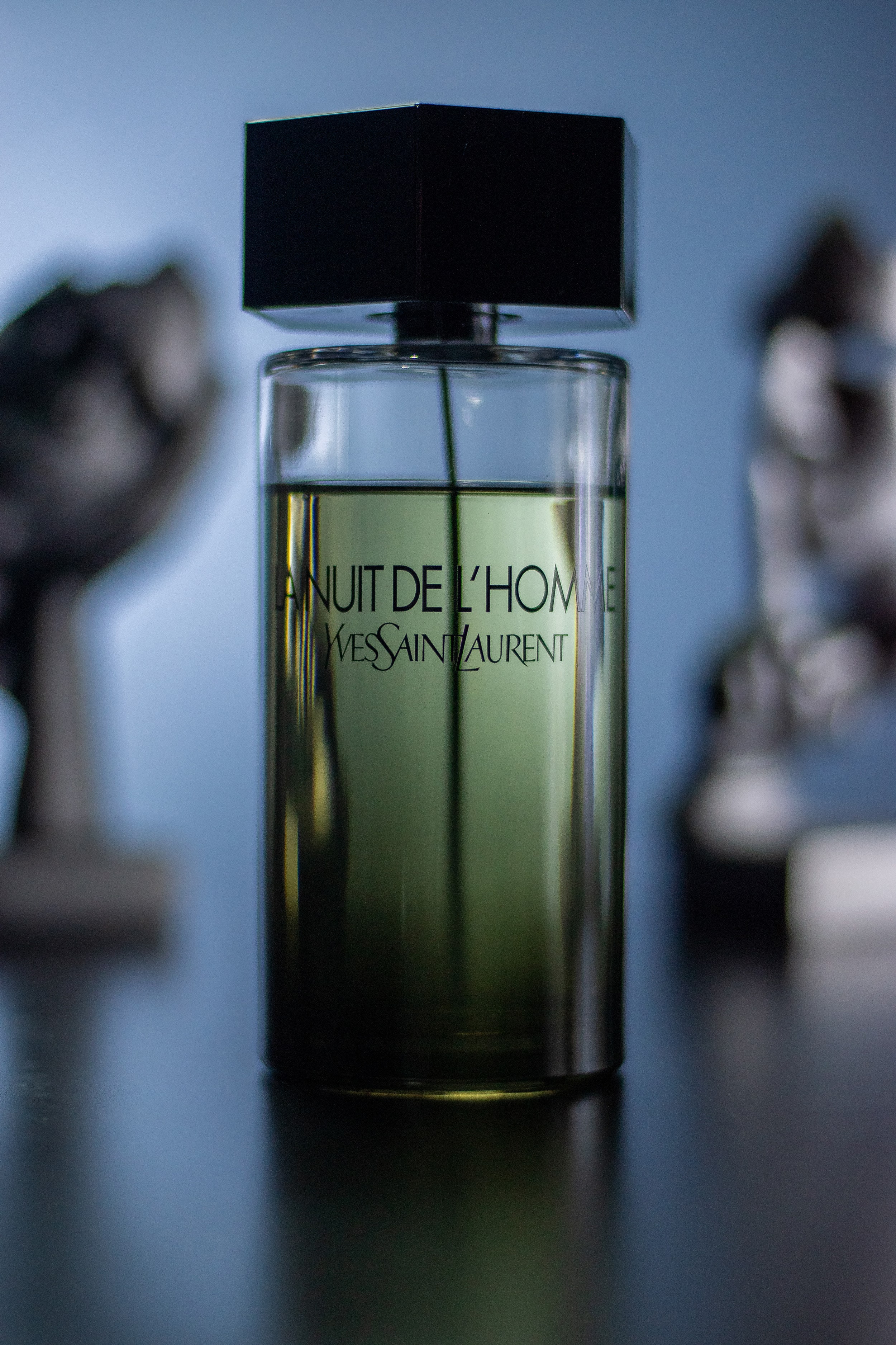 Angled cinematic shot of La Nuit de L’Homme with white light illuminating its sleek design.