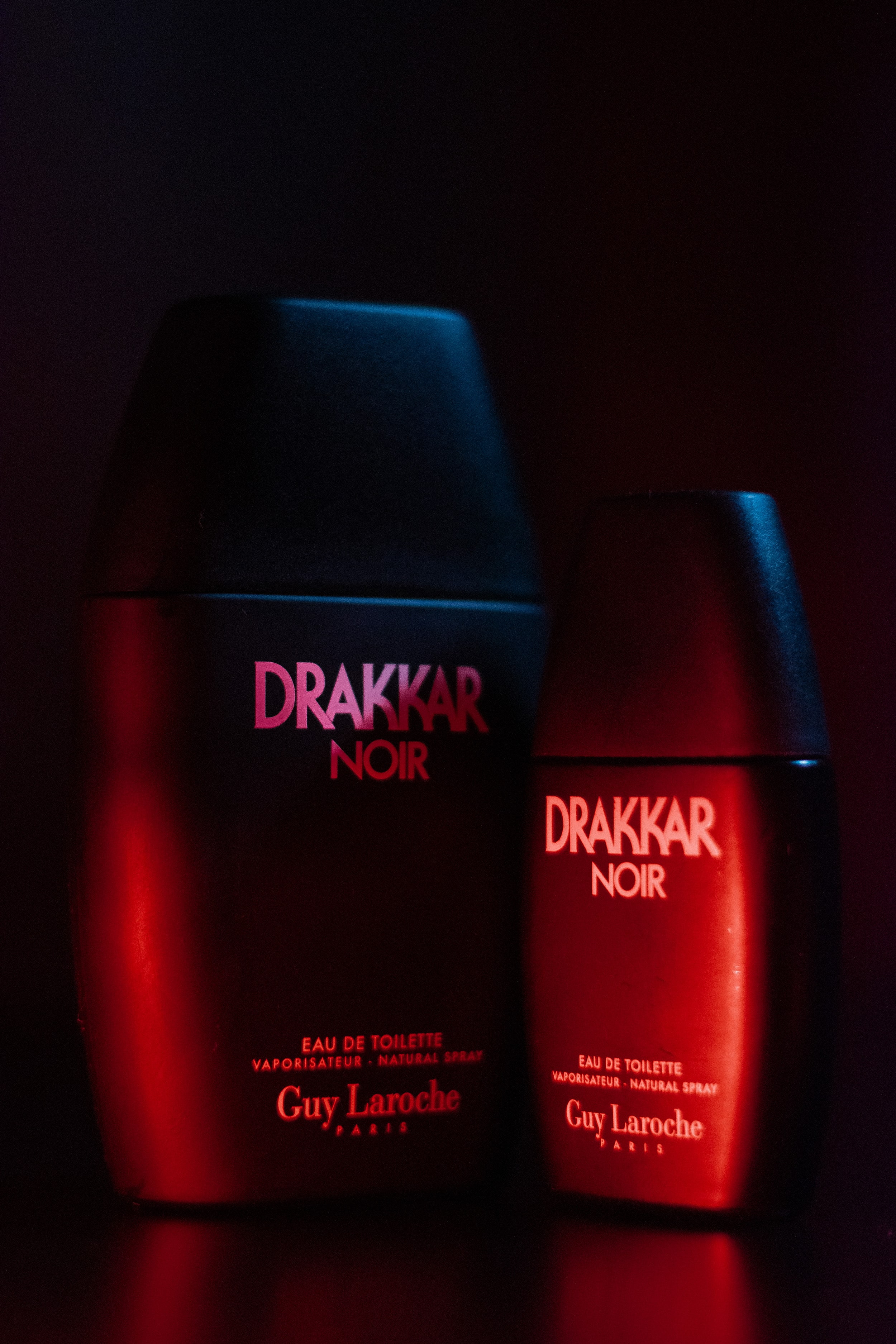 Drakker Cologne in a film-inspired shot, with blue and red lights creating a sleek, editorial look.