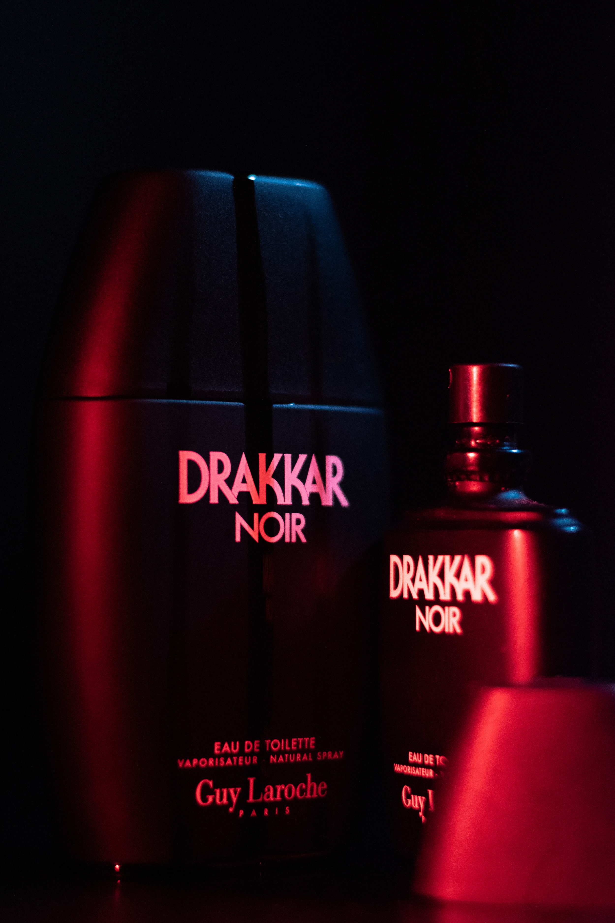 Drakker Cologne displayed with a dramatic, cinematic color contrast of blue and red lighting.