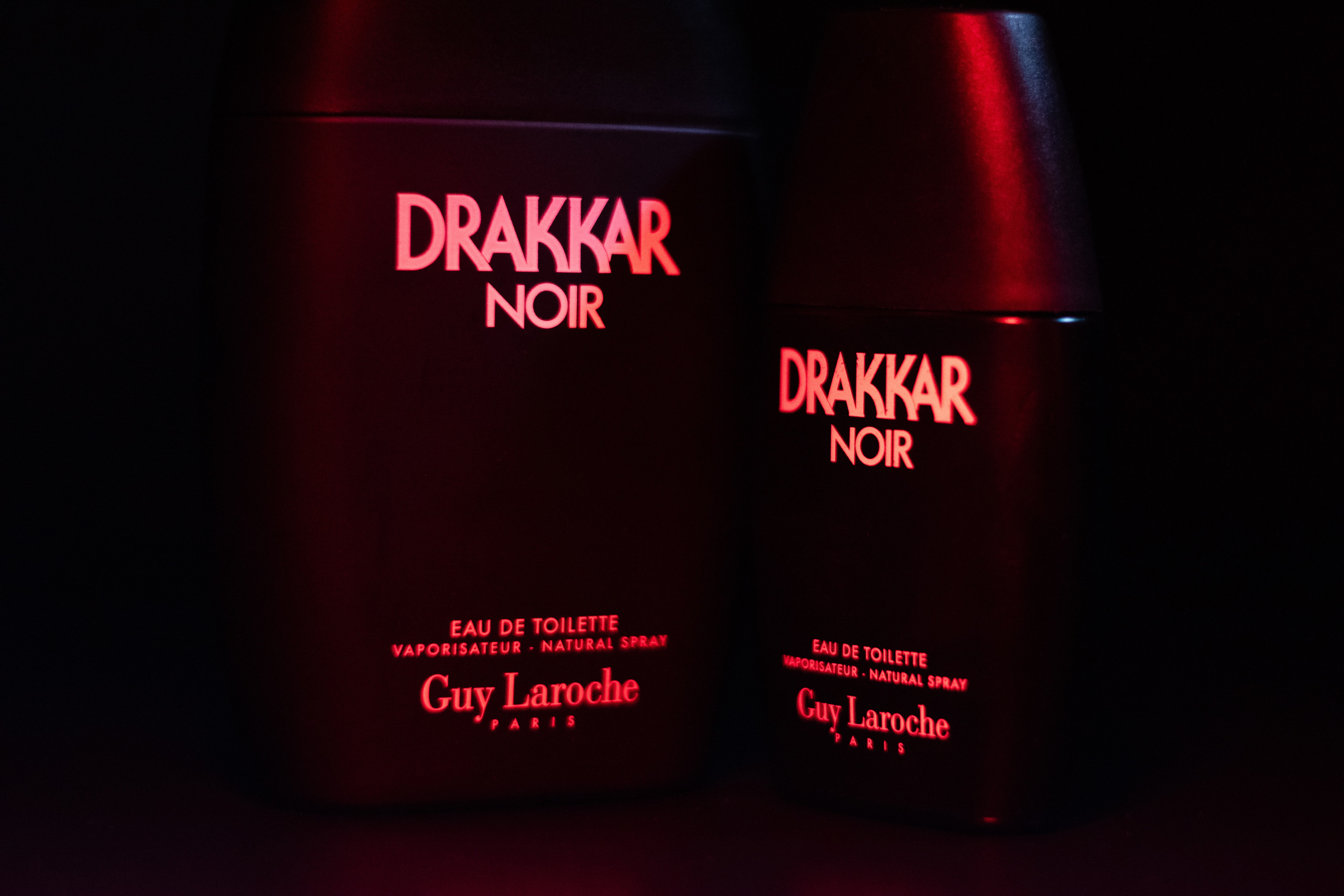 Drakker Cologne in a stylized, film-like scene, where red lighting create a dramatic, moody atmosphere