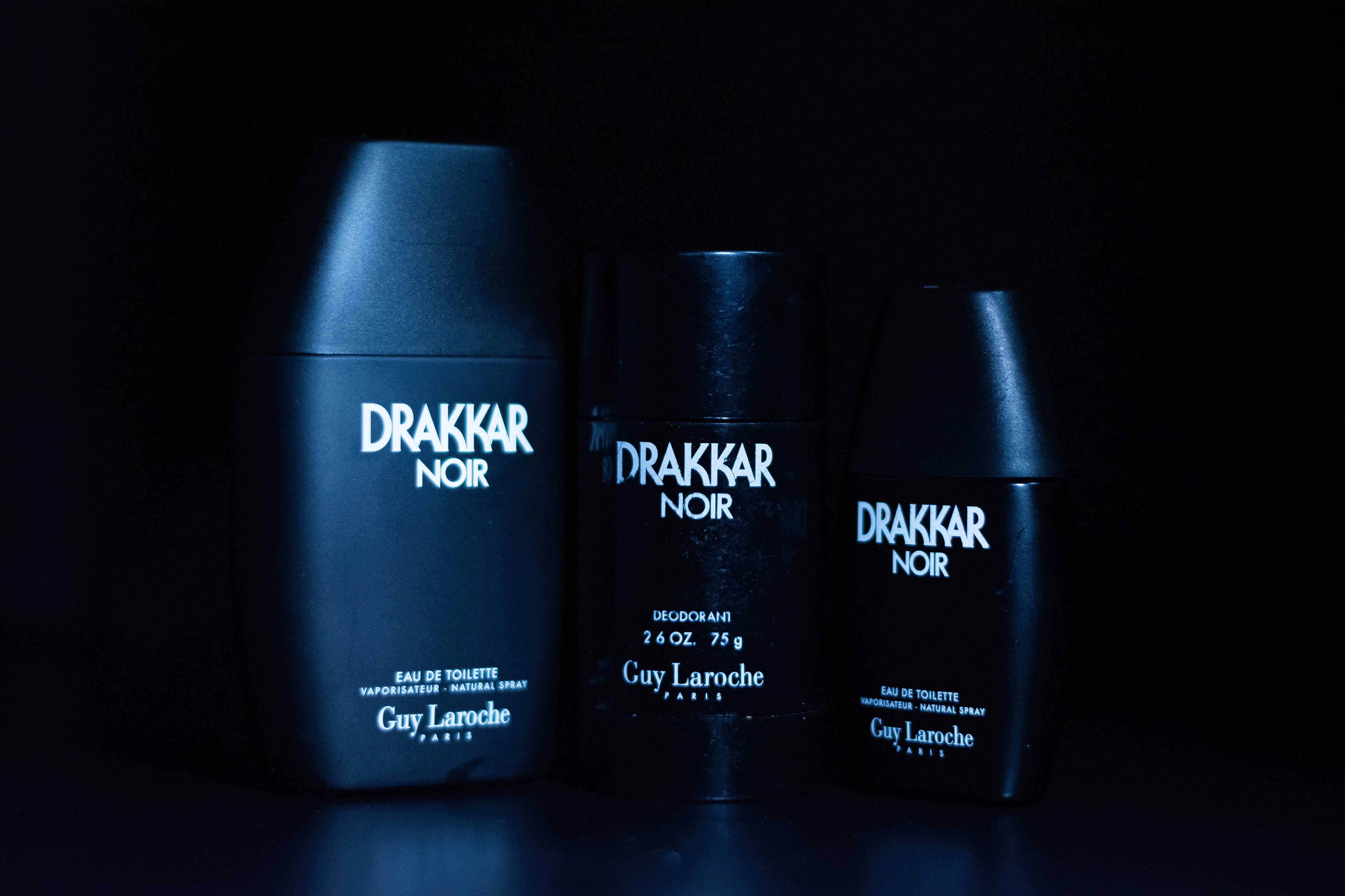 Drakker Cologne displayed in a cinematic setting with dramatic blue light casting shadows and highlights.