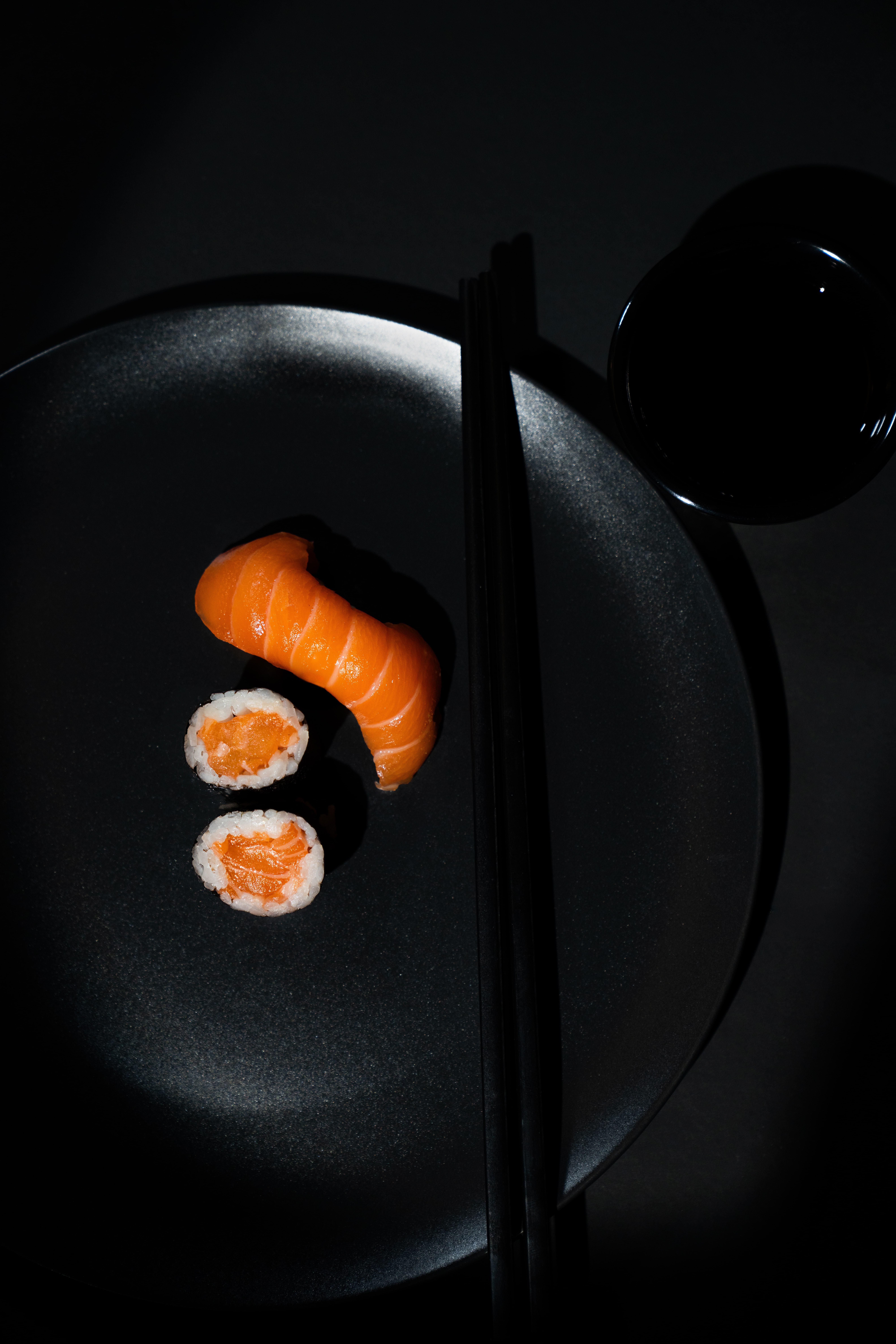 Sushi presented in a cinematic, film-style setting with moody lighting and rich textures.