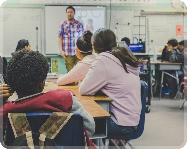 Students in class listening to the teacher