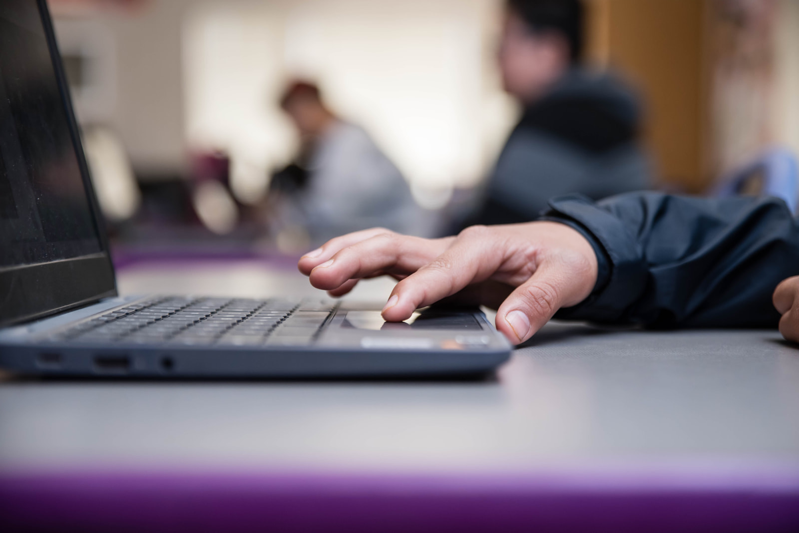 A student typing on a laptop