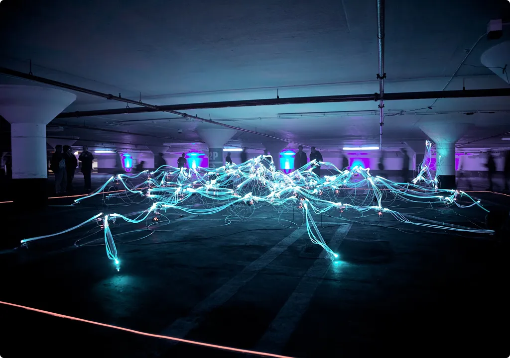 A group of people standing around a room with lights.