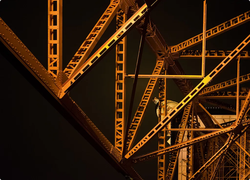 A close up of a metal structure with a clock on it.