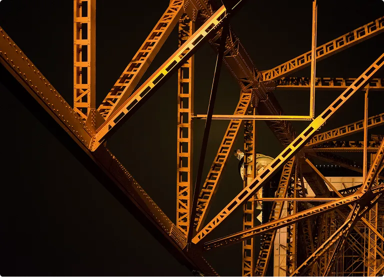 A very tall metal structure with a clock on it's side.