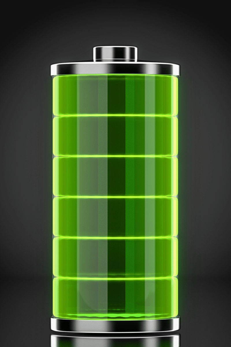 A macro shot of a green battery with glowing light