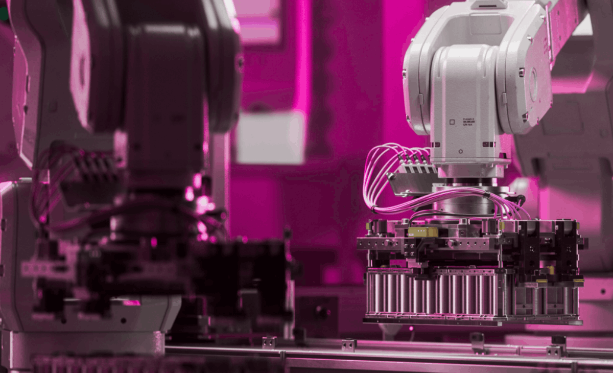 A close-up shot of a battery being manufactured with pink and high contrast colors