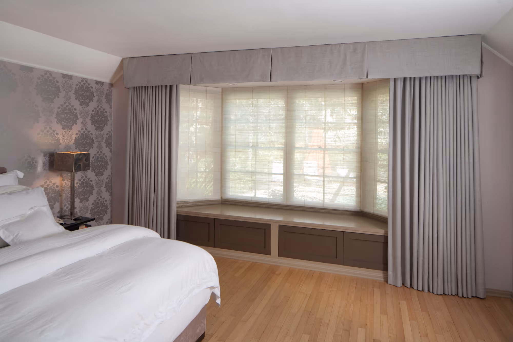 Sophisticated bedroom with elegant window valance and soft gray drapery in a Hollywood, CA home.