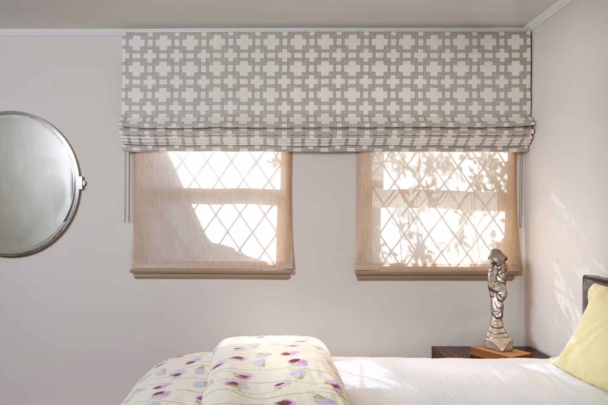 Elegant bedroom featuring roman shades with a cross pattern and soft bedding in hollywood, ca.