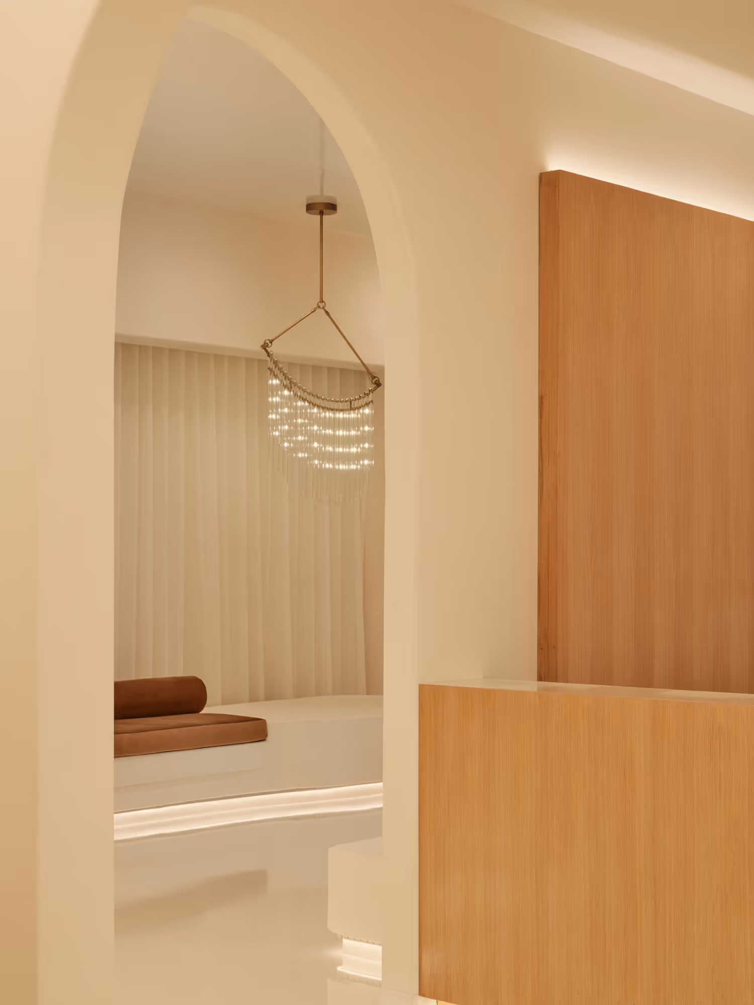 Modern dental waiting area in Dallas, TX featuring warm wood accents, soft lighting, and plush seating.