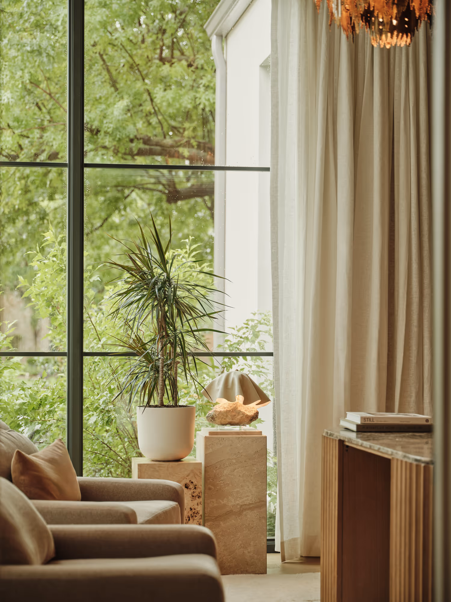 Modern living room in Preston Hollow, Dallas, TX featuring natural light, plush seating, and elegant drapery.