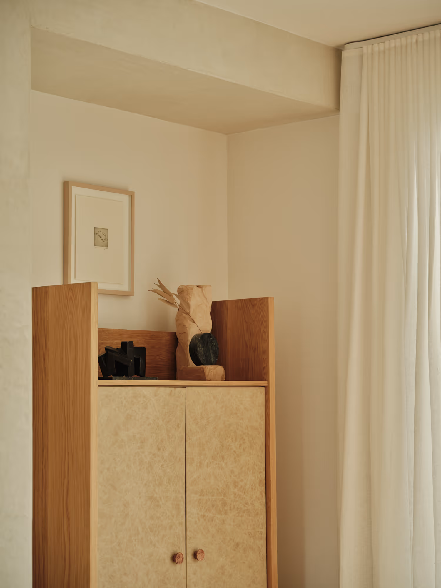 Minimalist bedroom design featuring a wooden cabinet and serene decor elements in preston hollow, dallas, tx.