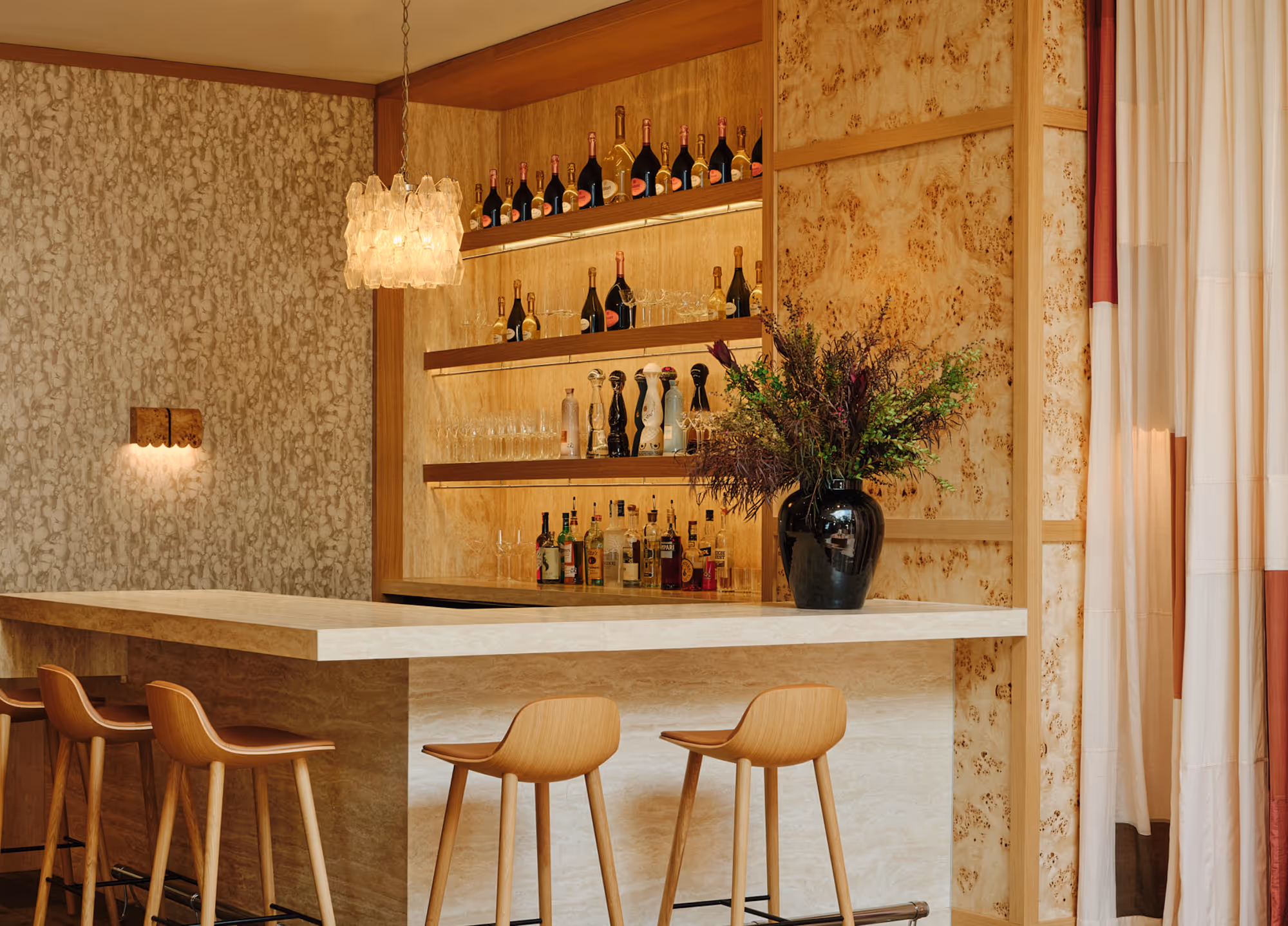 Luxurious commercial bar area with modern drapery, wood accents, and floral decor in Dallas, TX.