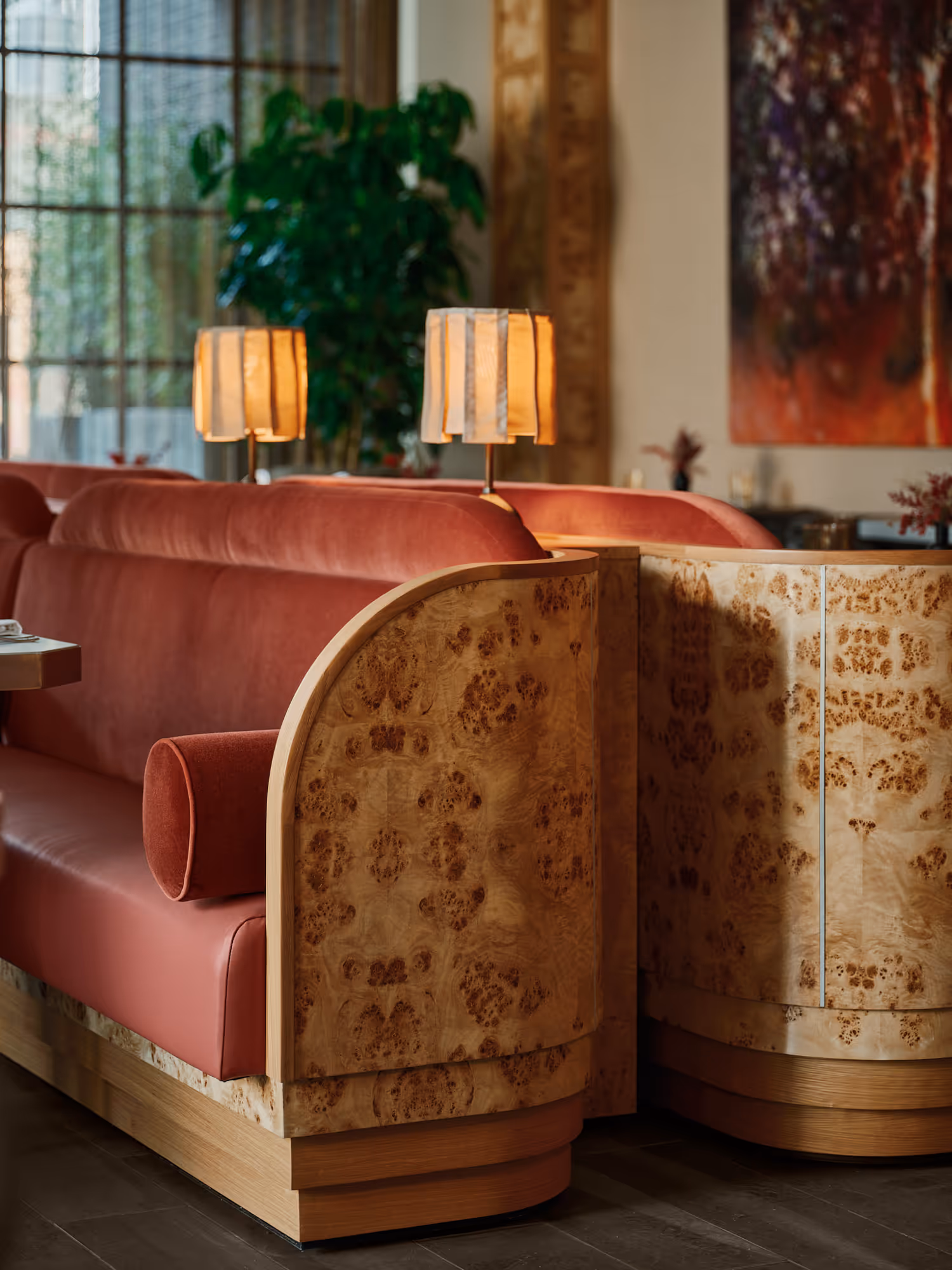 Stylish restaurant seating with plush red upholstery and decorative wood accents in Dallas, TX.